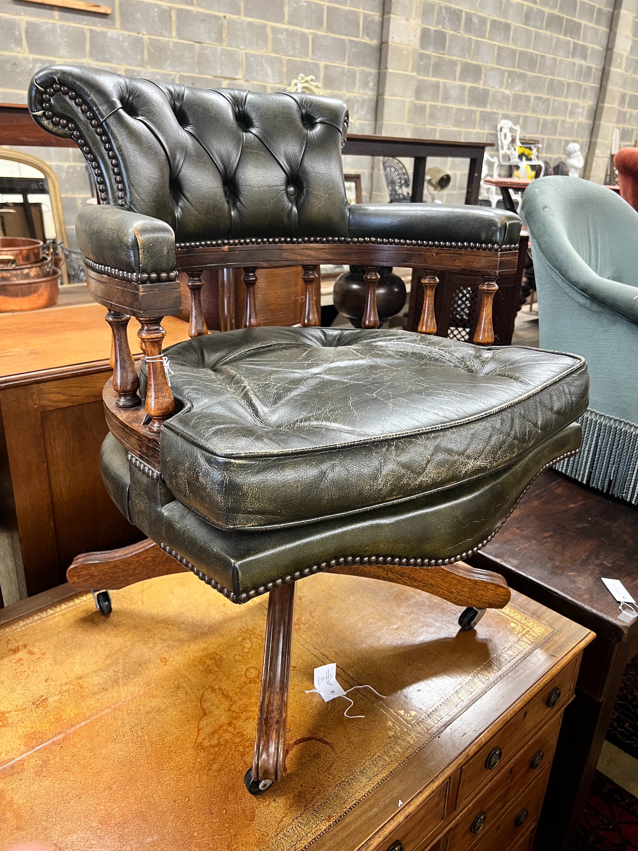 A Victorian style buttoned green leather mahogany swivel desk chair, width 62cm, depth 58cm, height 85cm